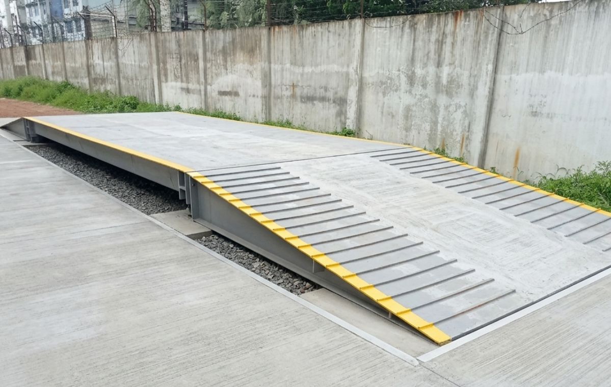 Heavy truck crossing an industrial weighbridge scale platform